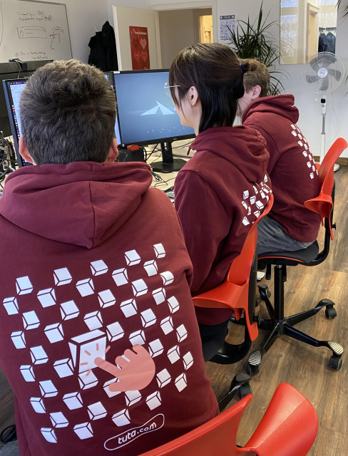 Tuta employees wearing matching hoodies. 