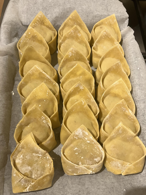 A tray of wonton dumplings ready to be cooked