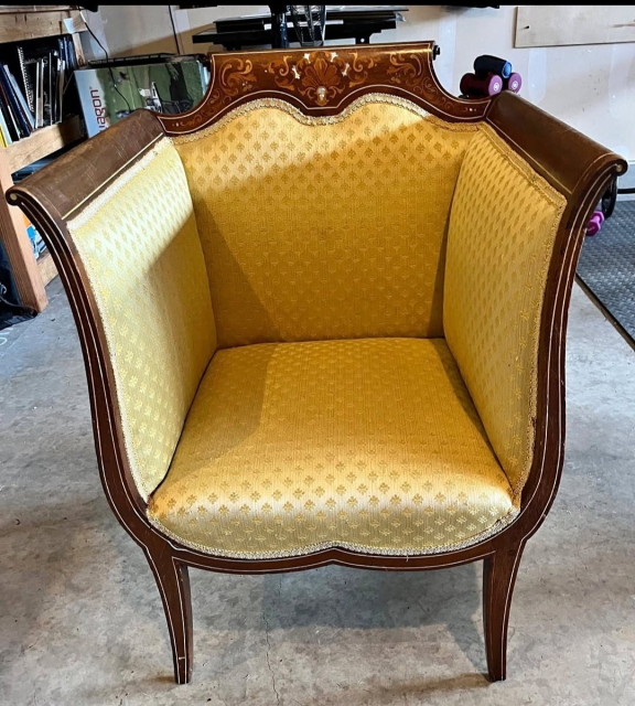 A Victorian-era hand-carved chair with a high back and and equally high sides, like four sides of a cube. Trying to sit in funny positions here would either be impossible or like an enrichment activity for a zoo animal.