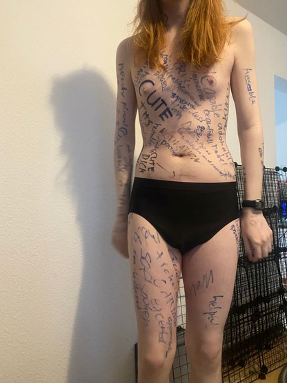 My front. Cute is written over my right boob. Other text says kissable, selfless, cute dick, humble, beautiful, adorkable, and nerdy, as well as a bunch of other text I can't make out