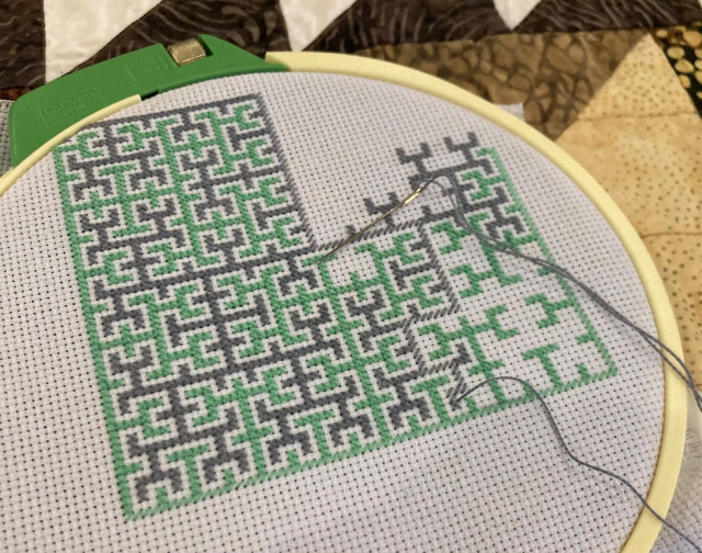 Negative-space cross-stitched 5th-iteration Hilbert Curve, looks about 2/3 done