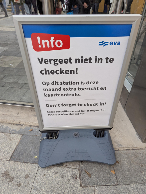 A sign next to starting:

!nfo GVB

Vergeet niet in te checken!

Op dit station is deze maand extra toezicht en kaartcontrole.

Don't forget to check in!

Extra surveillance and ticket inspection at this station this month.