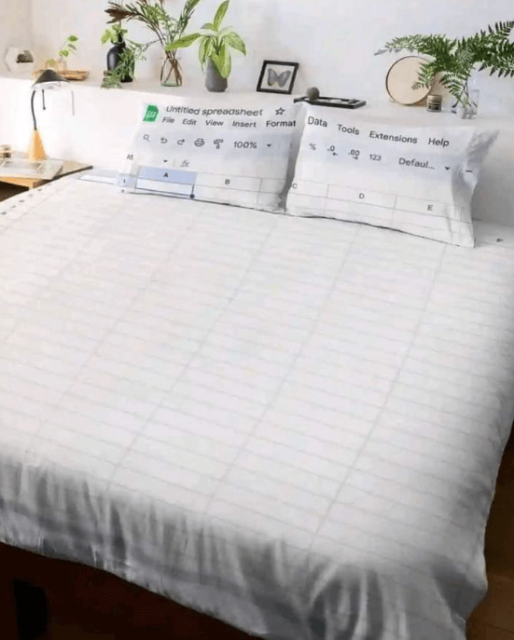 Photograph of a double bed with an excel themed bed cover and matching pillow cases 