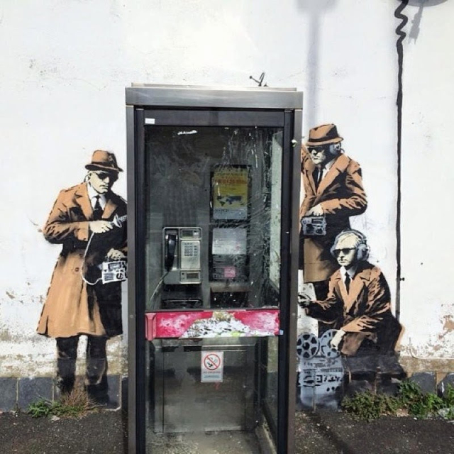 Banksy street art
"Phone box spies"