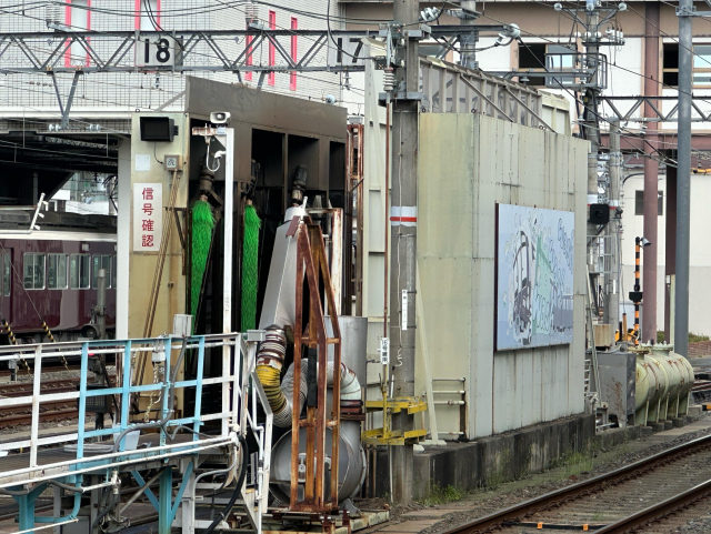 A large structure filled with rollers, sprayers, etc