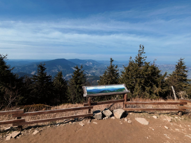 A view of other mountains from Lysa hora with infotable in front.
