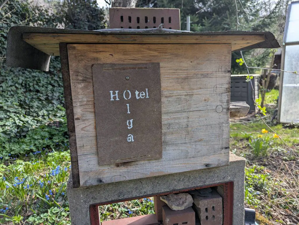 Ein Holzkasten mit Dach und einem Schild "Hotel Olga".