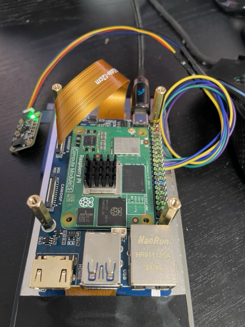 Underside, CM5 on a Pi shaped baseboard screwed onto the display, various wires connected