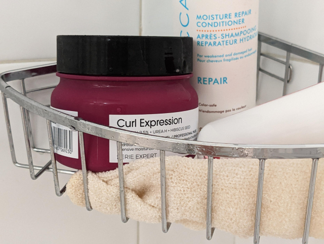 Photo of an after-shampoo bottle with "curl expression" written on it