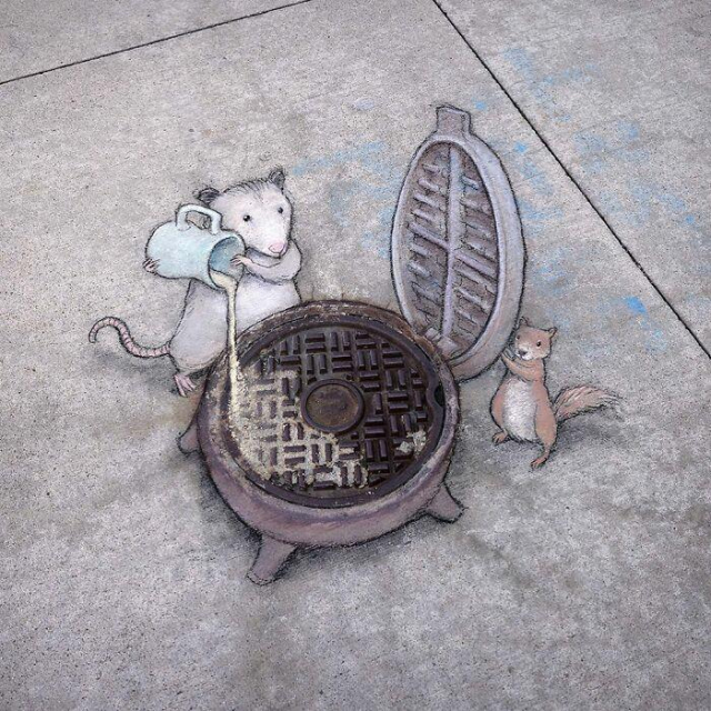 Two chalk drawn creatures, a mouse and a squirrel pour waffle mix into a manhole cover that's been repurposed as a waffle maker