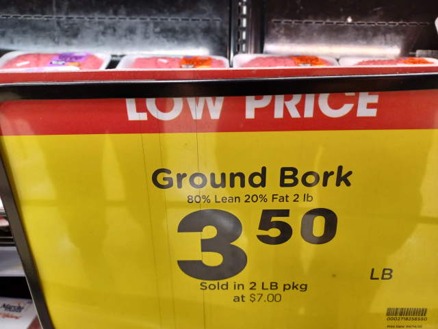 meat counter at grocery store, with sign saying "Ground Bork $3.50/lb"