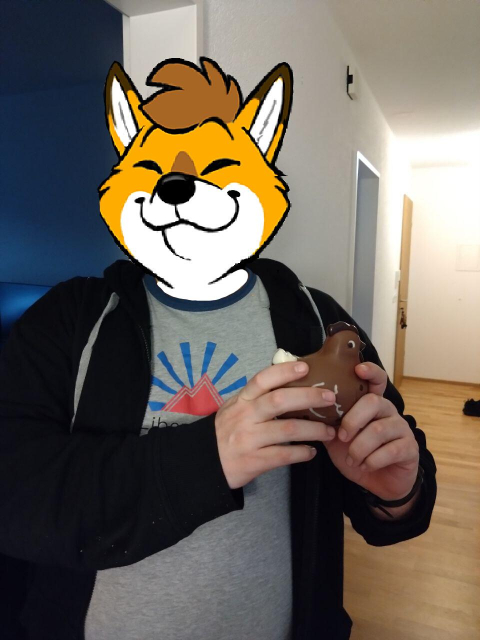 Photo of a person holding a small chocolate rooster.
Foxbrush's head is edited in over the actual head