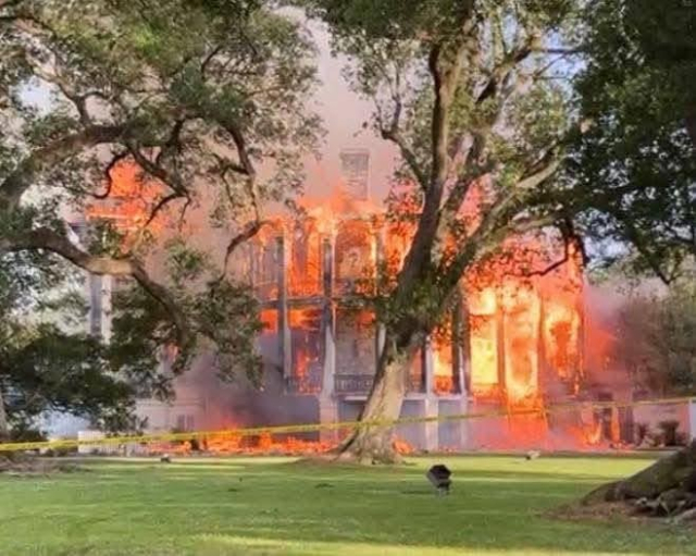 Picture of Nottoway Plantation engulfed in flames that assure it cannot be restored. 