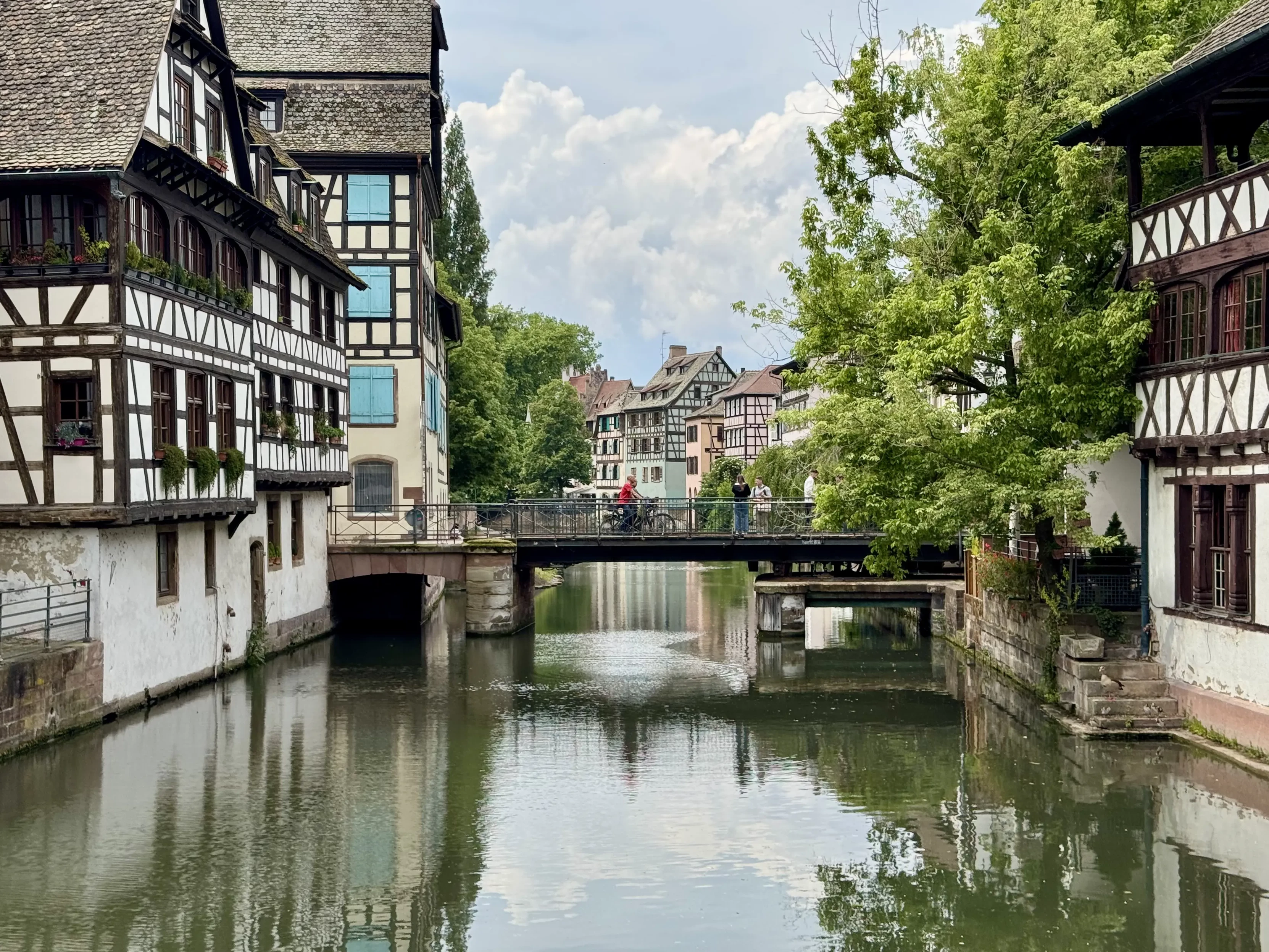 Another picture of a short bridge crossing the river, surrounded by half-timbered houses.