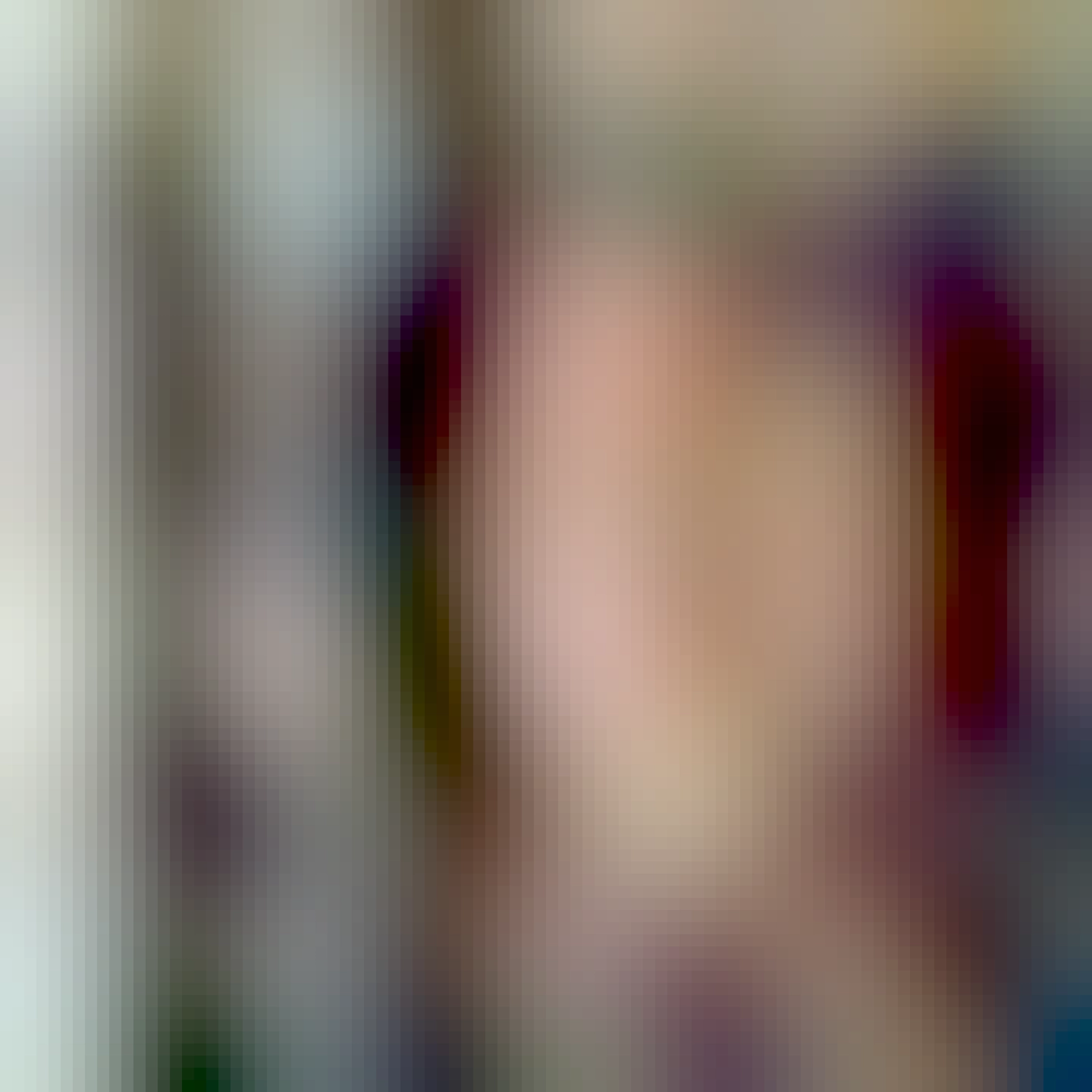 A photo of me, a 41-year-old white woman with long straight brown hair and blue eyes, wearing a black long-sleeved top and sitting on a train