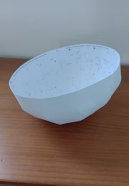 A small paper dome whose inside surface shows the night sky, plotted for the location and date from which students will be observing.