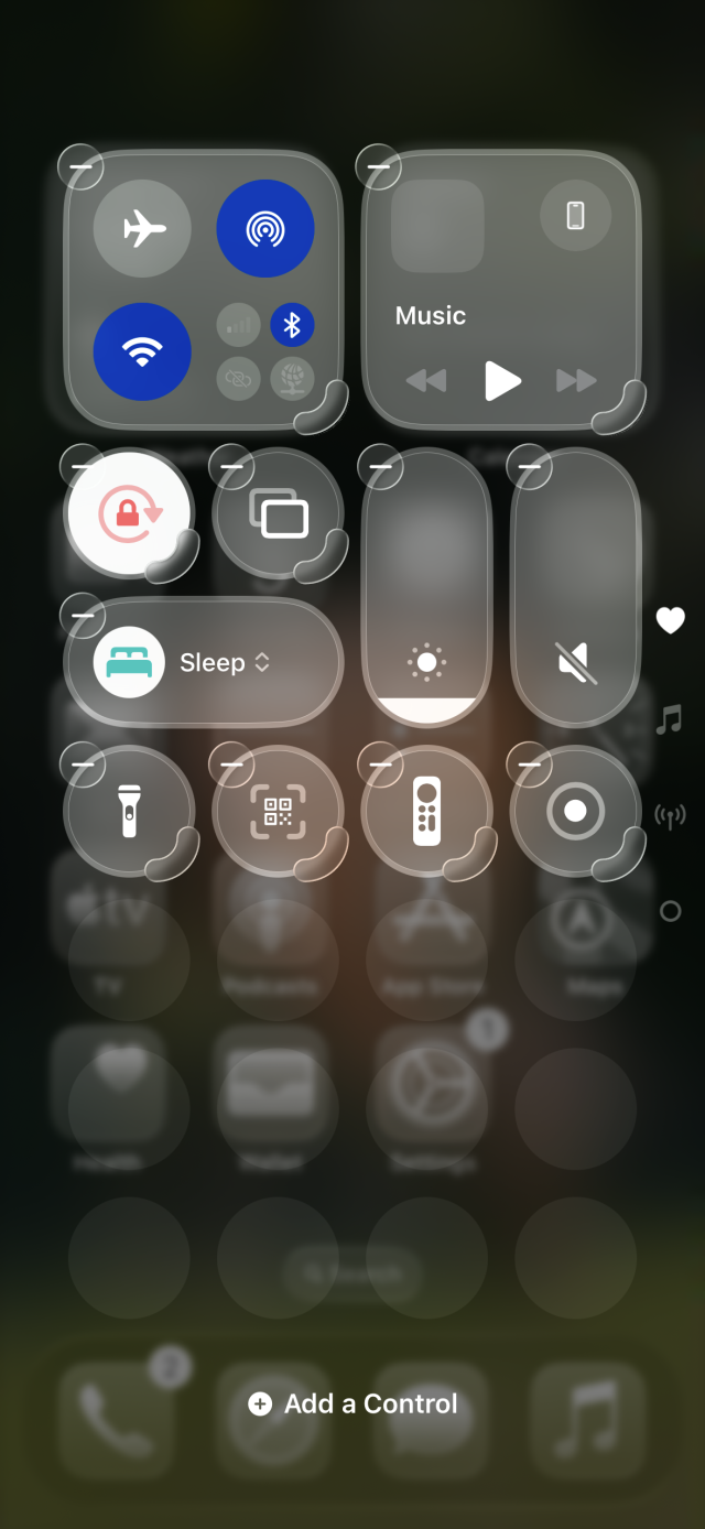 A screenshot of iOS 26 Control Center in editing mode. There are a lot of overlapping glass effects 