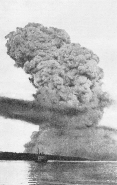 Black and white photo that shows a ship on the water and huge plume of smoke in the sky.