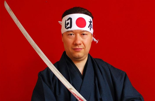 Tomio v kimonu, s čelenkou a katanou.