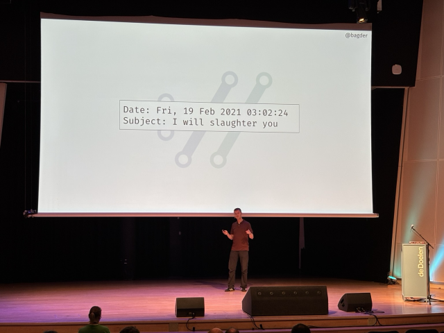 Daniel Stenberg, curl’s maintainer, presenting a slide with an email he received with the subject “I will slaughter you”