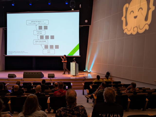 Hannes Mühleisen on stage at Joy of Coding. 