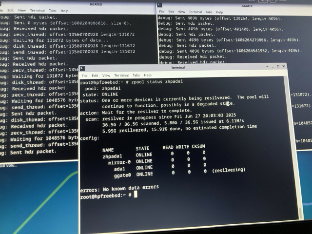 Three terminal windows: on the left the verbose ggated(8) output while a disk is being exported to a remote another machine. On the right the verbose output of ggatec(8), while using the disk of the aforementioned daemon. In the middle, overlapping the other two windows, is the output of a zpool status command, showing that a device called ggate0 is being resilvered in a ZFS mirror configuration.