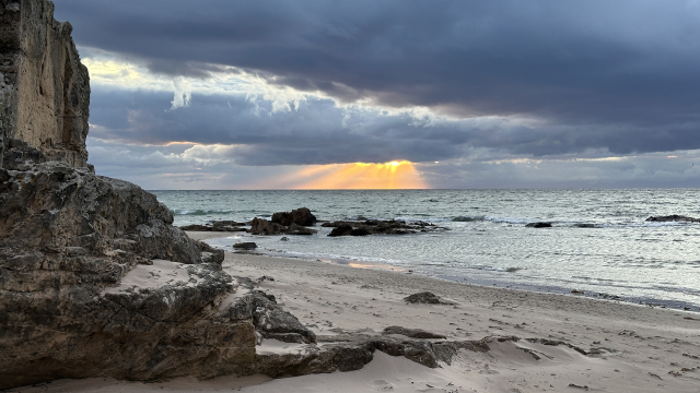 Sunset over the North Sea as seen from a rocky beach 