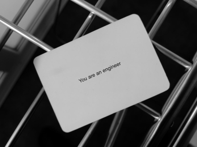 A black-and-white photo of an Oblique Strategy card. The card reads: 'You are an engineer'.