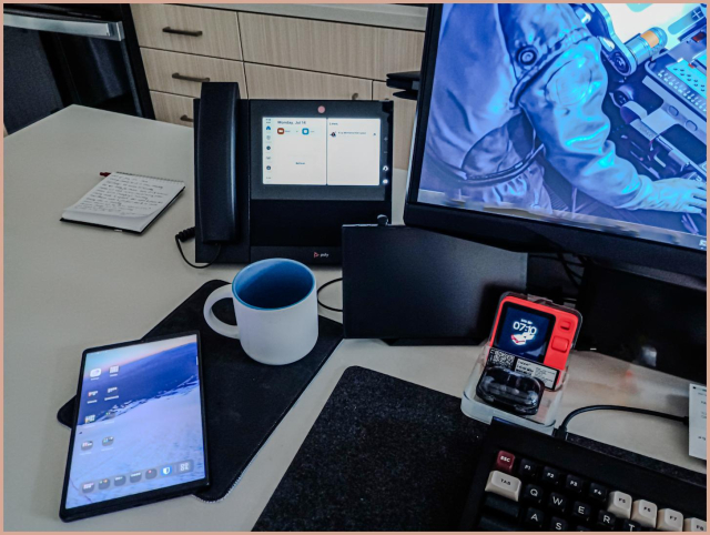 a SIP phone appears at Eva's desk m nestled among the various additional devices, each with a separate purpose.