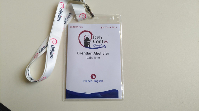 A photo of my DebConf 25 badge, showing my name and nickname (babolivier)