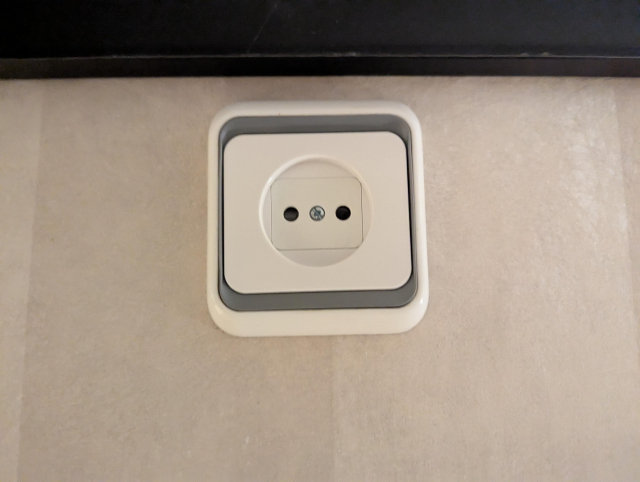 A CEE 7/1 unearthed socket on a wall.