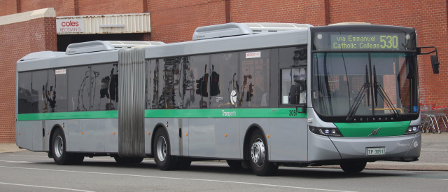 A silver-green articulated bus