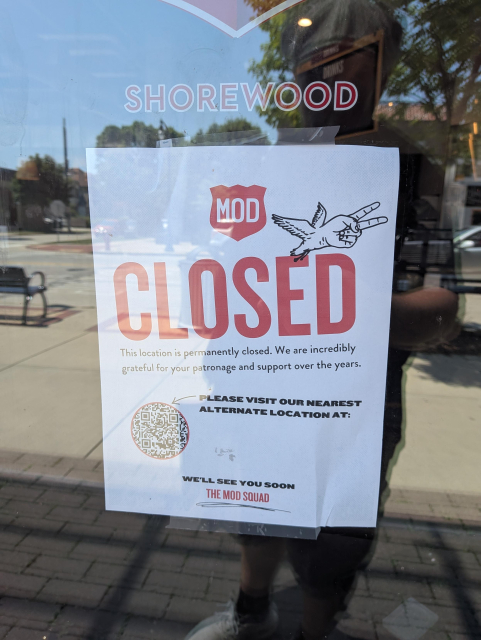 A sign saying that the mod Pizza location in Shorewood is permanently closed