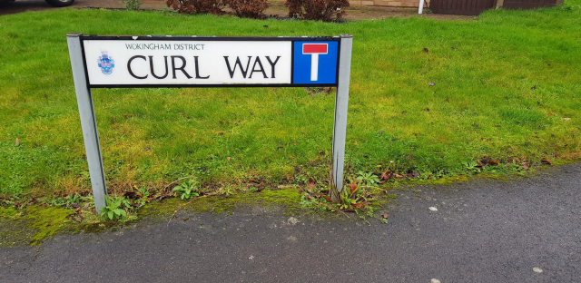 A road sign saying "curl way"
