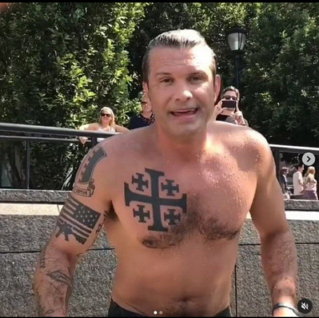 A photo of current US Defense Secretary Pete Hegseth shirtless in a swimming pool. He has a large crusader cross tattooed on his chest. Other tattoos of crosses, a US flag & rifle, and a heraldry shield are also visible.