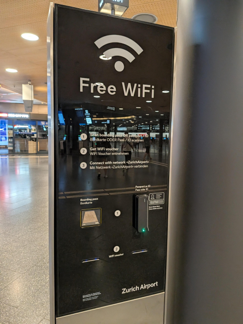 "Free WiFi" sign at ZRH airport stating that you have to scan your boarding pass to access the WiFi via a voucher or you need to scan your passport data to be ID'd.