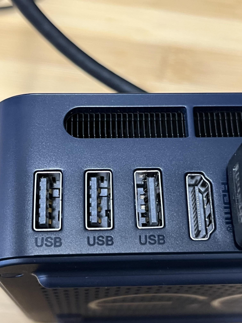 Photo of the back of a device with 3 USB-A  and an HDMI connection. One of the USB-A spots, however, is reversed. Good luck plugging that in blindly.