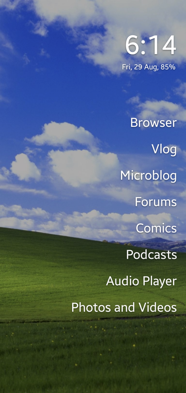A screenshot of a homescreen. The wallpaper is Bliss. It lists apps called: browser, vlog, microblog, forums, comics, podcasts, audio player, and photos and videos. It tells the time, date, and battery life as 6:17 Fri, 29 Aug, 85%