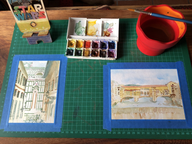 The two previous watercolors of Firenze, now more developed. I have started to add building details and some lines. The Firenze cathedral is thankfully very geometric, and maybe the buildings that frame it in the narrow street can just have an idea of window shutters and a few pipes, and shade to bring out the light of the cathedral in the center. The bridge is detailed but seems manageable; I don't need an exact copy but rather the idea of organized complexity from something that grew over time. Also, the reflections on the water seem to take more importance as I look at the original photo.