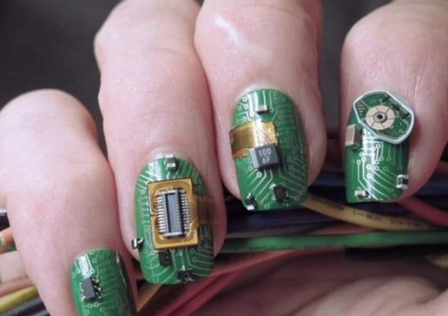 4 fingers, with circuitry patterns and components as decoration on the nails