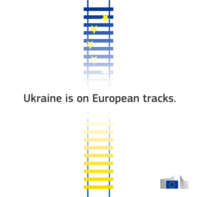 A railway track is shown in the middle of the image, with the top half coloured in the yellow and blue stripes of the Ukrainian flag. The track fades into a reflection below, which is coloured with the blue and gold stars of the European Union flag. The text “Ukraine is on European tracks” is centred in the image. In the bottom right corner is the logo for the European Commission. 