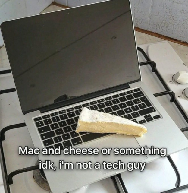 A pun-based meme with the caption, "Mac and cheese or something idk, i'm not a tech guy". The photo shows a literal interpretation of the phrase: a large wedge of soft cheese is sitting on the keyboard of a silver MacBook laptop, which is placed on a stovetop. 