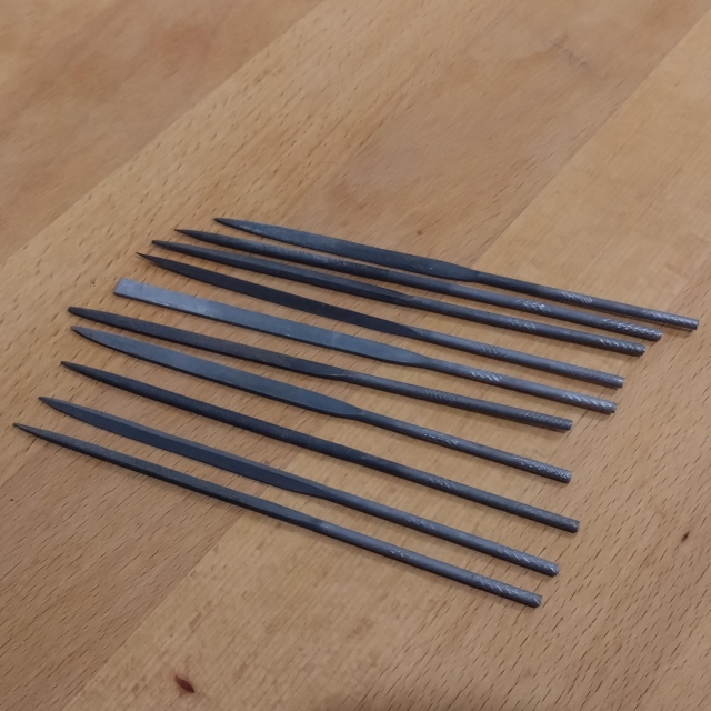 Photo of a bunch of metal files, unsorted.