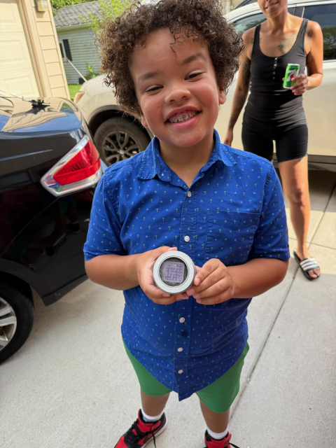 A kid showing off what he got for his birthday