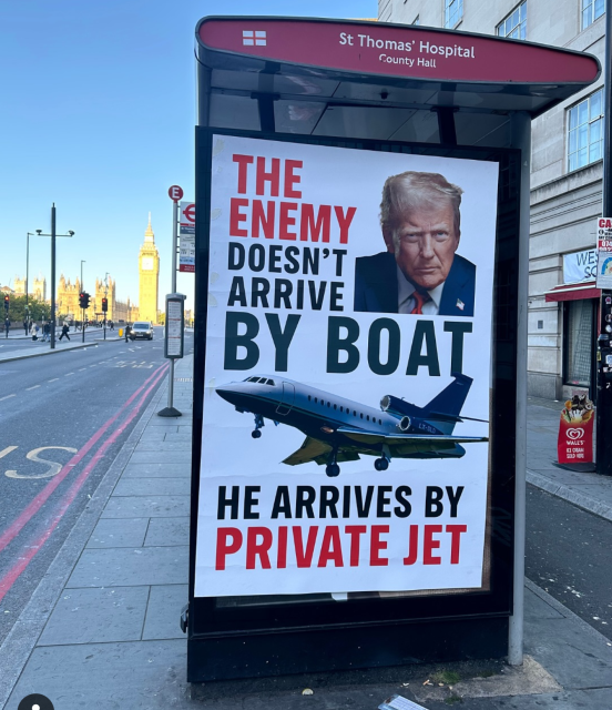 Bus stop at St. Thomas’ Hospital. A poster on the stop has a picture of Trump and a picture of Air Force 1.  Text:
The enemy doesn’t arrive by boat
He arrives by private jet