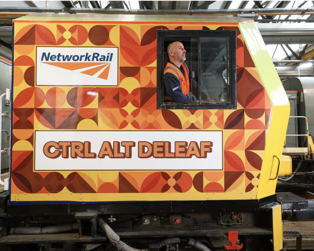 Image of train painted in 70s pattern - oranges, reds and yellows - with the name 'Ctrl Alt Delete' along the side