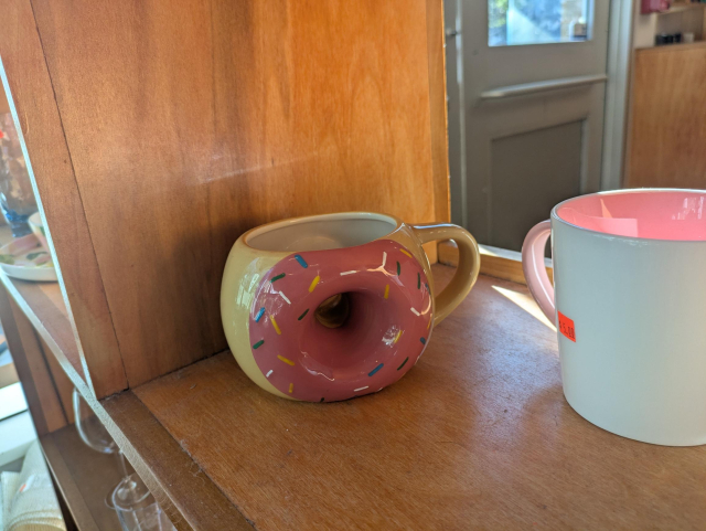 A mug that shapes like a donut, where it has a hole in the container.