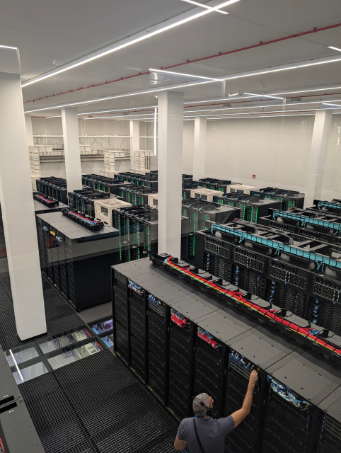 A server-room with lots of racks showing both CPU and GPU and lots of water cooling 
