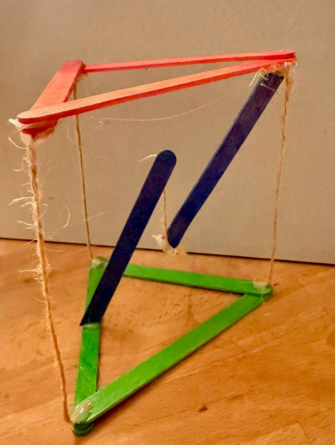 Simple tensegrity tower from red, green and blue ice lolly sticks an string.