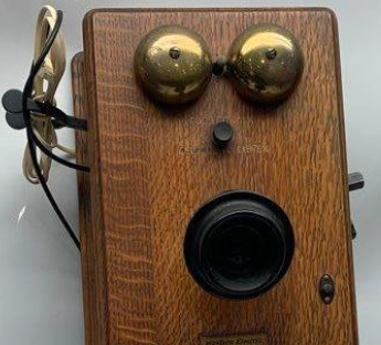 Telephone that looks like it has two eyes a nose and a mouth ready to kiss someone
